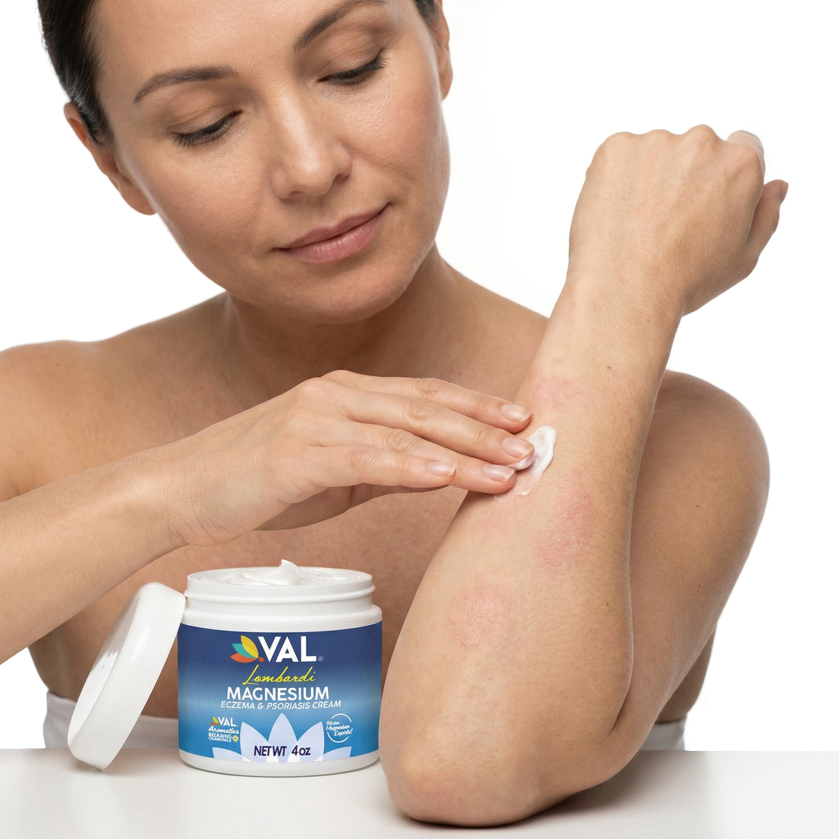 Woman applying VAL Lombardi magnesium cream on arm for eczema and dry skin relief